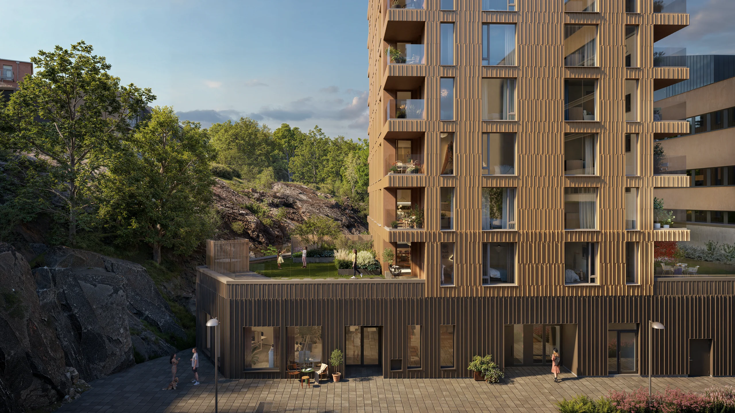 Ekedalsterrassens nedre våningar med uteplatser intill berg och grönska